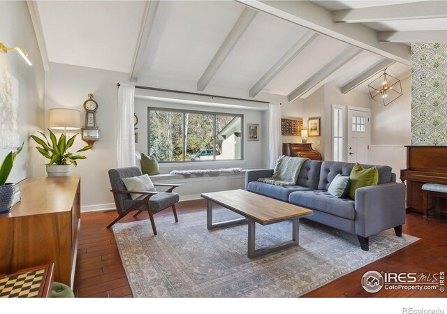 living area featuring lofted ceiling with beams, an inviting chandelier, and hardwood / wood-style floors