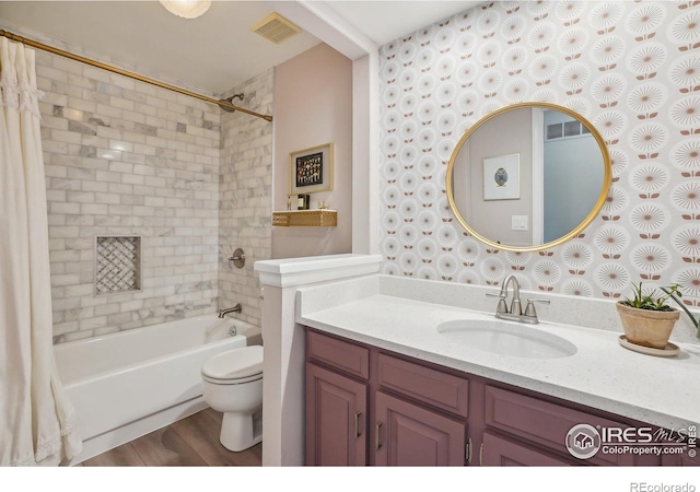 bathroom featuring toilet, wallpapered walls, visible vents, and shower / bath combo with shower curtain