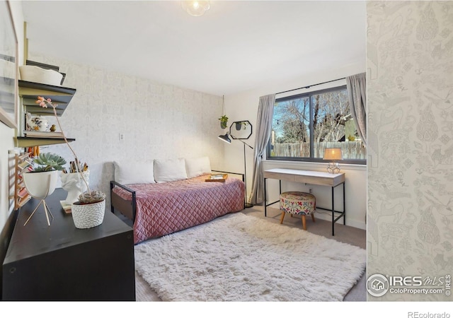 bedroom with carpet floors, baseboards, and wallpapered walls