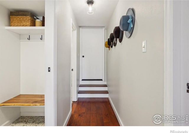 corridor featuring hardwood / wood-style floors and baseboards