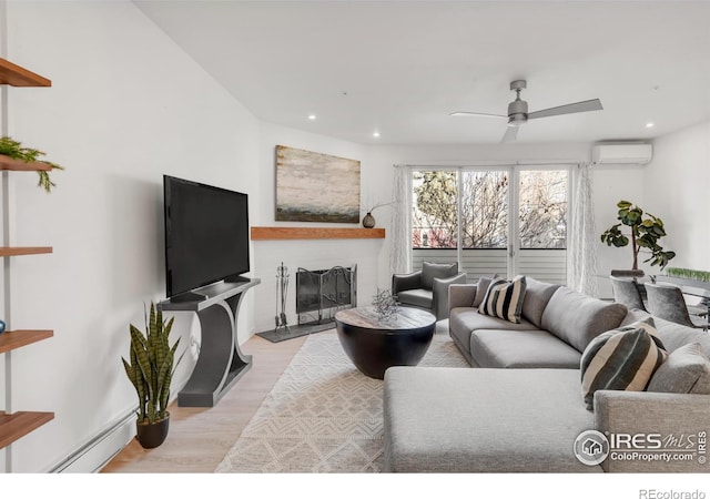 living room with a fireplace with raised hearth, a wall mounted air conditioner, light wood-style floors, a baseboard heating unit, and recessed lighting