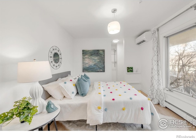 bedroom featuring a baseboard heating unit and a wall mounted AC