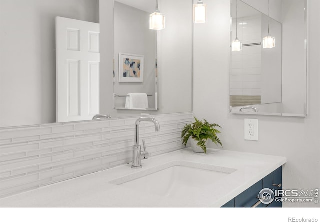 bathroom with tasteful backsplash and vanity