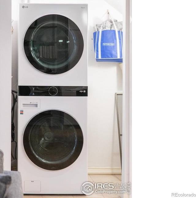 2444 9th St Unit 4, Boulder, CO 80304 - laundry room with stacked washer / dryer and tile patterned floors
