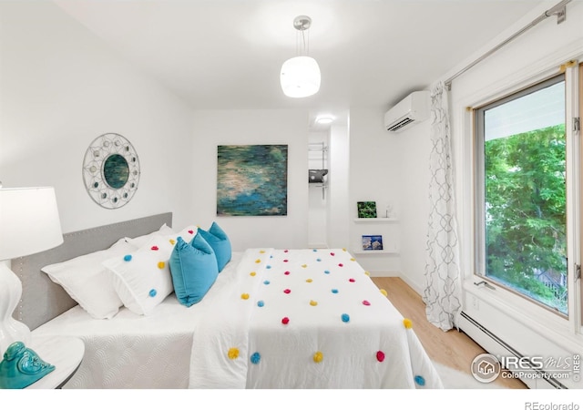 2444 9th St Unit 4, Boulder, CO 80304 - bedroom featuring a wall unit AC, wood finished floors, and baseboard heating