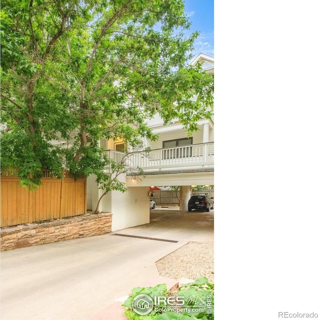 2444 9th St Unit 4, Boulder, CO 80304 - view of front facade featuring stucco siding, a carport, and a balcony