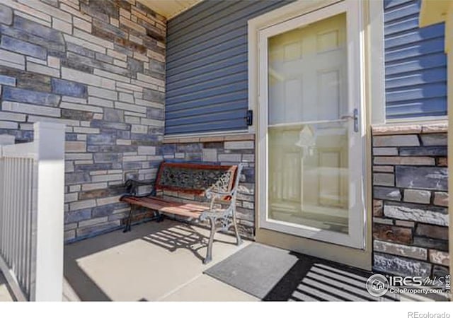 view of exterior entry featuring stone siding