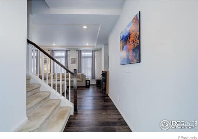 foyer featuring recessed lighting, wood finished floors, baseboards, and stairs