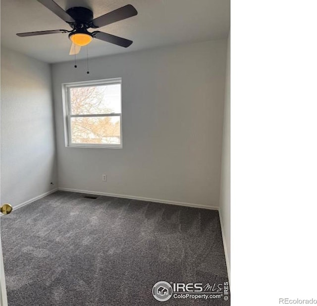 empty room with visible vents, dark carpet, baseboards, and ceiling fan