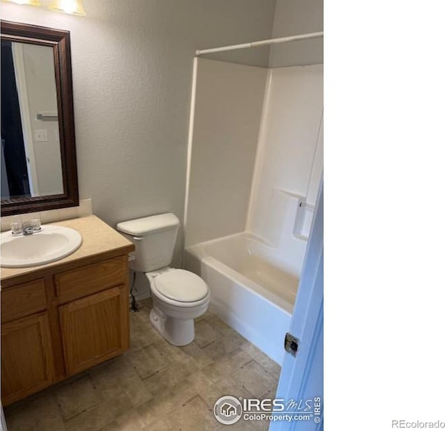 full bath with bathtub / shower combination, vanity, and toilet