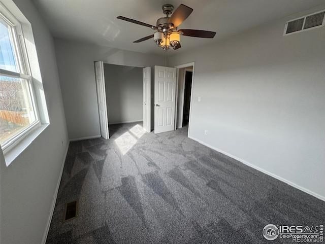 unfurnished bedroom featuring baseboards, visible vents, and carpet flooring