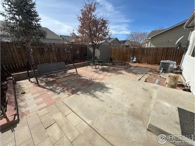 view of patio with cooling unit and a fenced backyard