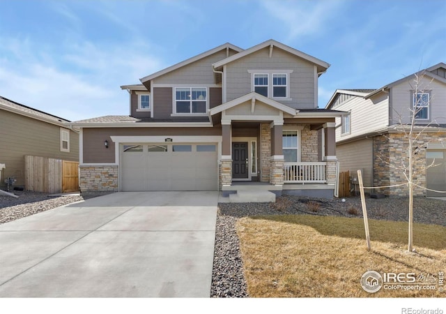 craftsman-style home with driveway, a garage, stone siding, covered porch, and fence