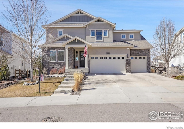 craftsman house featuring a garage, stone siding, board and batten siding, and concrete driveway