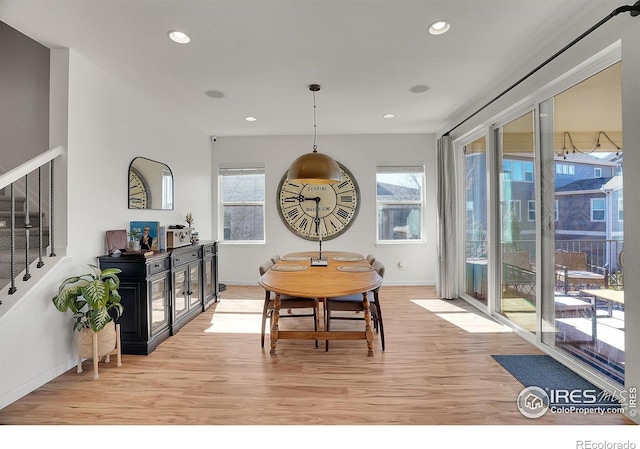 dining area with recessed lighting, a healthy amount of sunlight, stairway, and light wood finished floors