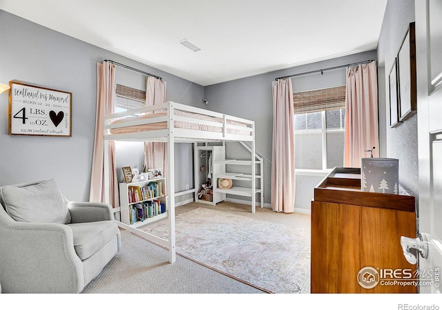 bedroom featuring carpet flooring and visible vents