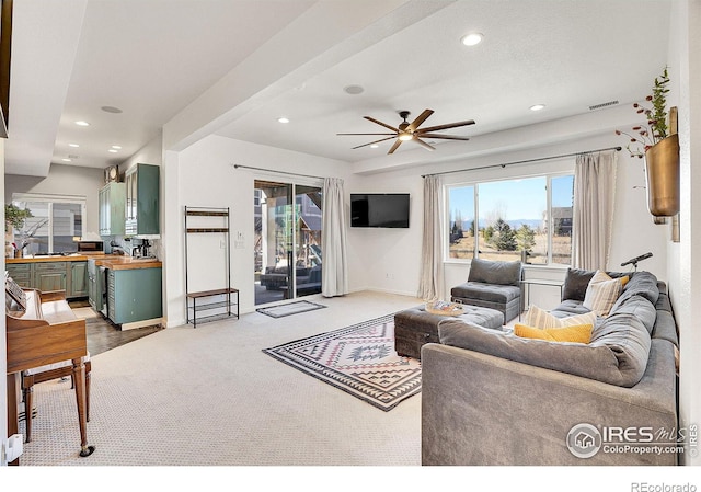 living room featuring recessed lighting, visible vents, dark carpet, ceiling fan, and baseboards