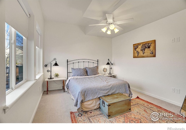 carpeted bedroom featuring baseboards and a ceiling fan