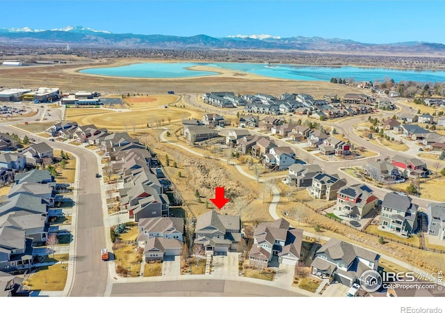 aerial view featuring a residential view and a water and mountain view