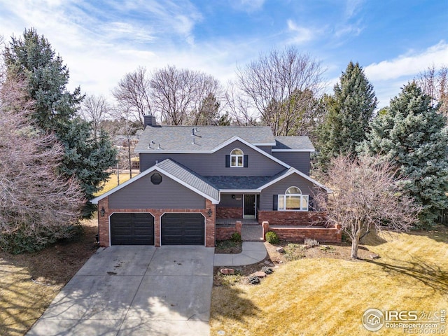 traditional-style house featuring an attached garage, roof with shingles, a front yard, brick siding, and driveway