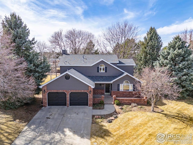 traditional home with a front yard, an attached garage, brick siding, and driveway