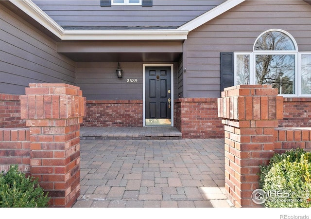 entrance to property with brick siding