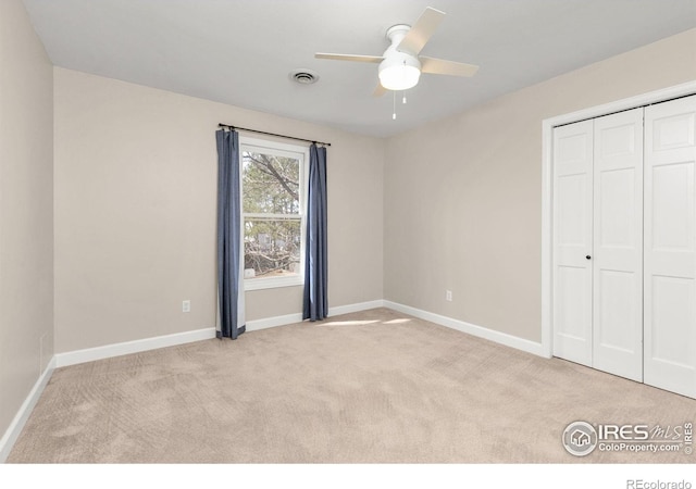 unfurnished bedroom featuring visible vents, ceiling fan, baseboards, carpet, and a closet