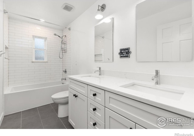 bathroom with tile patterned flooring, toilet, visible vents, and a sink