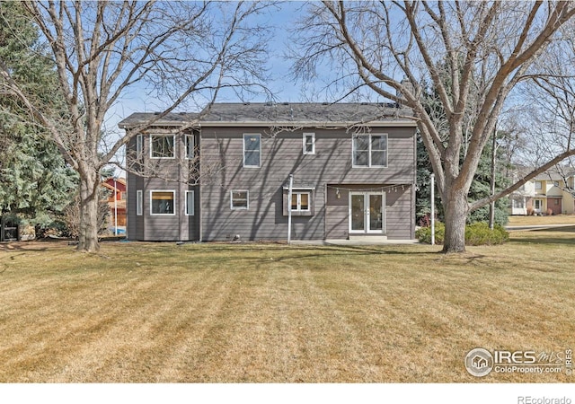 back of house featuring a yard, a patio area, and french doors