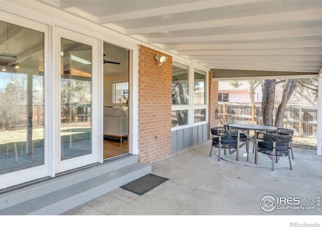 view of patio / terrace featuring entry steps, fence, and outdoor dining space