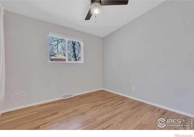 unfurnished room featuring visible vents, ceiling fan, baseboards, and wood finished floors