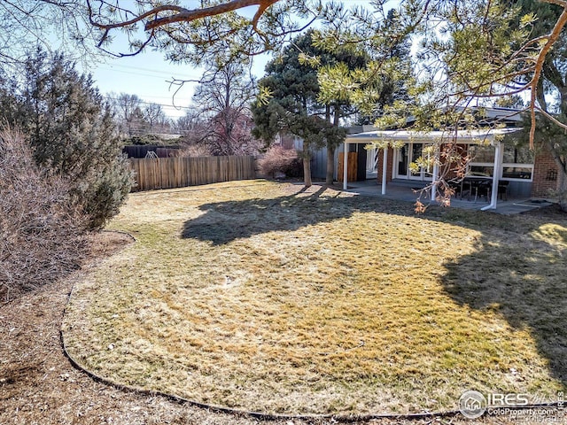 view of yard featuring a patio area and fence