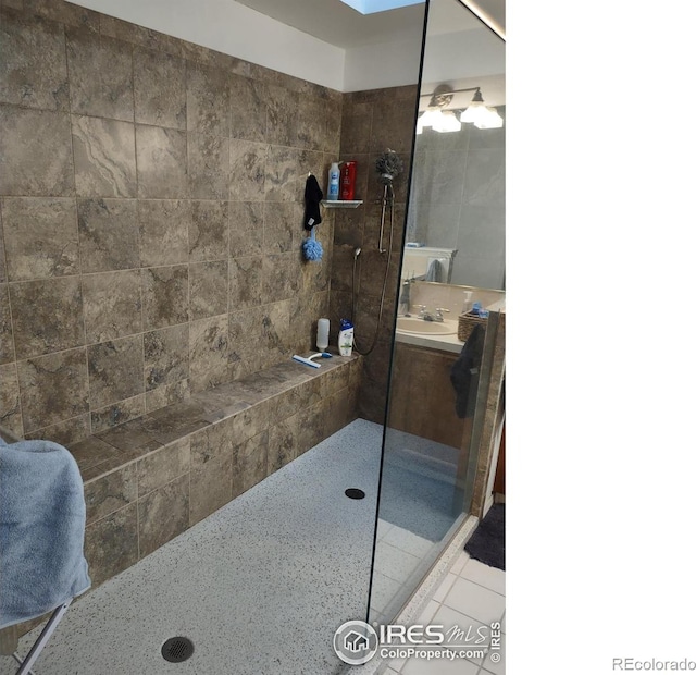 full bathroom featuring tile patterned floors, vanity, and walk in shower