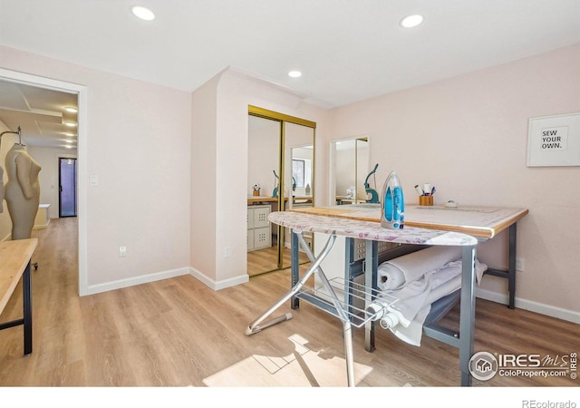 office space featuring baseboards, wood finished floors, and recessed lighting