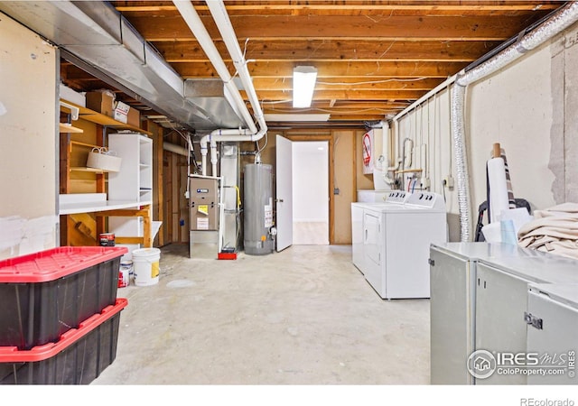 unfinished below grade area with washer and clothes dryer and gas water heater