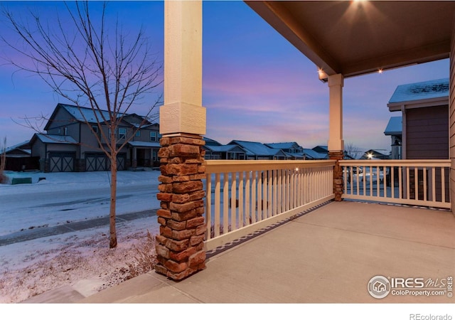 patio terrace at dusk featuring a residential view