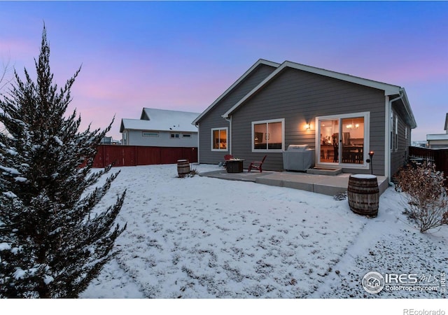 snow covered property featuring fence