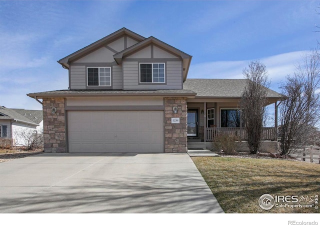 view of front of home with driveway, covered porch, a shingled roof, stone siding, and a garage