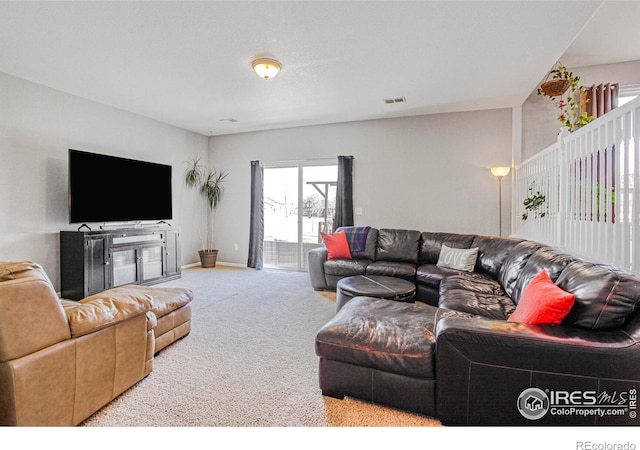 carpeted living room with visible vents and baseboards