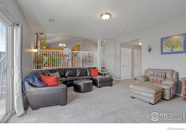 living area with a notable chandelier, carpet flooring, baseboards, stairs, and vaulted ceiling