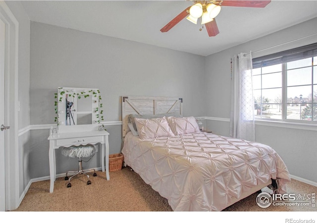 carpeted bedroom with baseboards and a ceiling fan