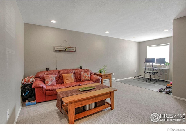 living room featuring carpet flooring, recessed lighting, baseboards, and a textured ceiling