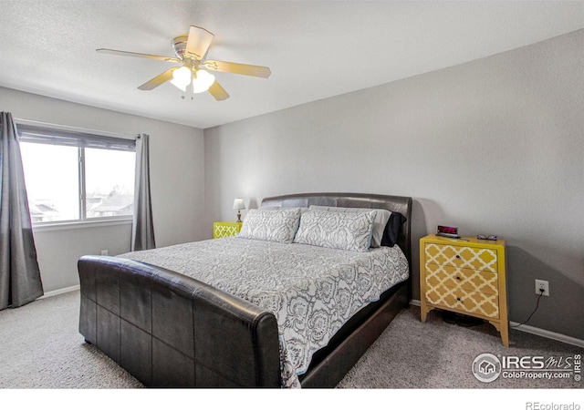 bedroom with ceiling fan, baseboards, and carpet