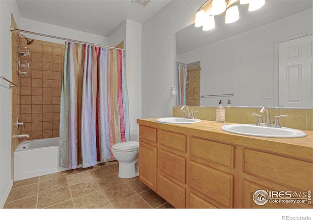 bathroom with a sink, toilet, double vanity, and shower / bath combination with curtain