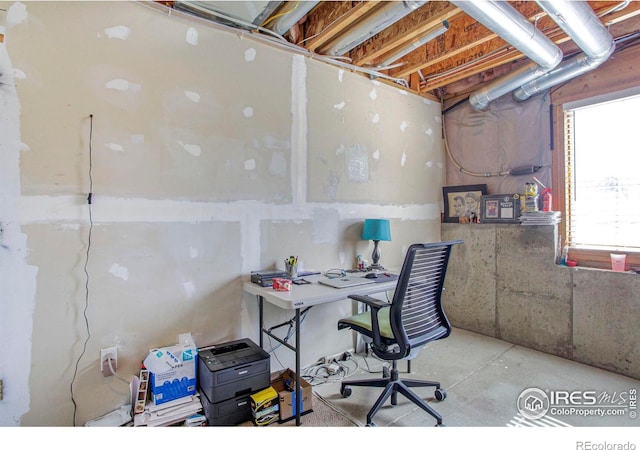 office space with unfinished concrete flooring