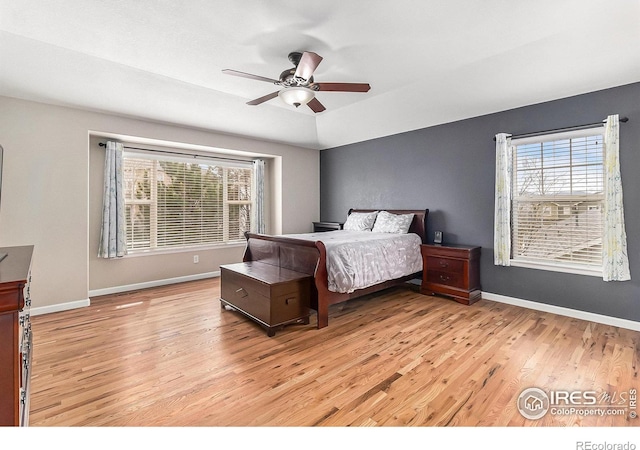 bedroom with light wood-style floors, baseboards, and a ceiling fan