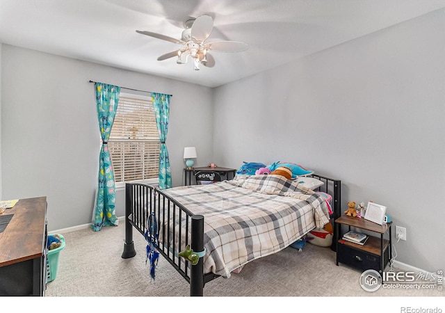 carpeted bedroom featuring a ceiling fan and baseboards