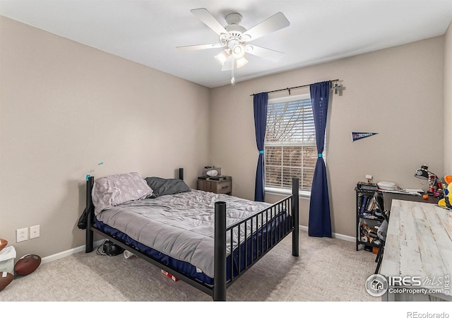 carpeted bedroom with ceiling fan and baseboards