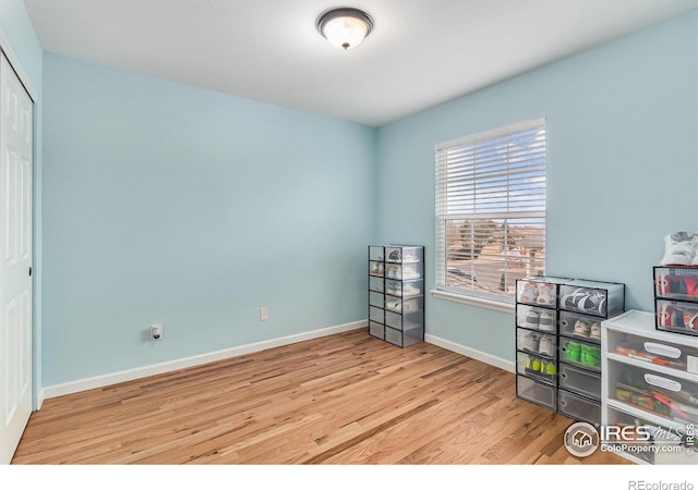 interior space with wood finished floors and baseboards