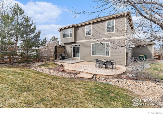 rear view of house featuring a lawn, a patio area, and fence